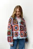 A woman wearing a colorful crocheted cardigan. Produktbild-Vorschau