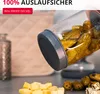 A close-up shot of a jar filled with pickles, tilted to show the contents. In the foreground, there are diced cheese cubes and olives. Anteprima dell’immagine prodotto