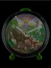 A dinosaur-themed alarm clock against a black background. Produktbild-Vorschau