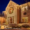A house decorated with Christmas lights and wreaths at night. Produktbild-Vorschau