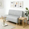 A modern living room or dining area with a sofa, side table, and artwork. Produktbild-Vorschau