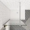 A top-down view of a modern bathroom shower enclosure with white tiled walls and a patterned floor. Produktbild-Vorschau