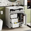 A white bathroom vanity with drawers and a door, featuring a sink and faucet. The background includes green tiled walls and patterned wallpaper. Podgląd zdjęcia produktu