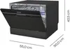 A black countertop dishwasher with its door open, showing internal racks. Dimensions are indicated by lines and text. Produktbild-Vorschau