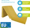 A yellow folding mattress is shown in a partially folded position, with marketing icons and text on the right side and a 'Made in EU' logo at the bottom left. Produktbild-Vorschau