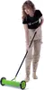 A woman is using a manual lawn aerator on a white background. Produktbild-Vorschau