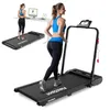 A woman is running on a treadmill in a home or office setting, with another treadmill and a standing desk in the background. Anteprima dell’immagine prodotto