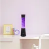 A desk with a lava lamp, a framed picture, and a clock. Anteprima dell’immagine prodotto