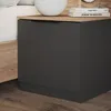 A close-up view of a modern nightstand with a dark gray drawer and a wooden top, placed next to a bed. Náhled obrázku produktu