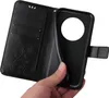 A hand holding a black flip phone case open, revealing the inside. Produktbild-Vorschau