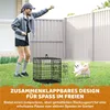 A woman is playing with a dog in a backyard next to a dog crate. Produktbild-Vorschau