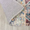 A close-up view of a rug, showing the texture and pattern of the material. The rug is partially rolled up, revealing the underside. Produktbild-Vorschau