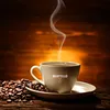 A cup of steaming coffee with coffee beans on a wooden surface, with a wooden background. Produktbild-Vorschau