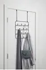 An over-the-door hook rack with a scarf, jacket, and purse hanging on it, mounted on a white door. Produktbild-Vorschau