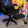 A person is interacting with a black gaming chair with an extended footrest. Produktbild-Vorschau