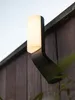 A modern outdoor wall light mounted on a wooden fence. Produktbild-Vorschau