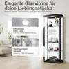 A glass display cabinet with items inside, shown in a room setting with a sofa and a window. Produktbild-Vorschau