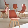 A group of six Scandinavian-style chairs with wooden legs, arranged on a tiered platform against a grey background. Produktbild-Vorschau