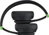 A close-up, side view of black headphones with green accents, folded. Produktbild-Vorschau