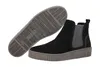 A pair of black Chelsea boots with a grey sole and grey elasticated side panels, shown from a slightly elevated side view with the sole of one boot prominently displayed. Produktbild-Vorschau