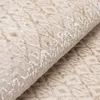 A close-up view of a beige carpet with a diamond pattern. Produktbild-Vorschau