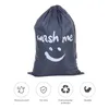 A gray laundry bag with a smiley face and the text 'wash me' printed on it, shown against a white background. Below the bag are four circular icons with text labels. Produktbild-Vorschau