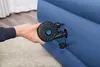 A hand is holding an electric pump to an inflatable blue mattress. Produktbild-Vorschau