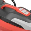 A close-up view of the handle and a label on a red and gray lawnmower. Produktbild-Vorschau