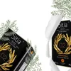 A product shot of olive oil packaging with decorative foliage. Produktbild-Vorschau