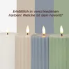 Four LED candles in different colors are displayed against a vertically striped background. Podgląd zdjęcia produktu