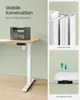 A desk with a weight on it, and close-ups of its construction and adjustable feet. Produktbild-Vorschau