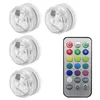 A set of four submersible LED lights and a remote control are displayed against a white background. Produktbild-Vorschau