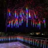 Decorative LED lights hanging from a tree and along a balcony railing at night. Náhled obrázku produktu
