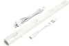 A white LED under-cabinet light bar with its accessories, including a power cord and mounting hardware, laid out on a white background. Produktbild-Vorschau