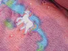 A close-up view of a fluffy fabric with a unicorn pattern. Anteprima dell’immagine prodotto
