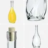 A collage of four images showing different views of glass bottles, one filled with yellow liquid and one with a cork stopper. Voir les images du produit