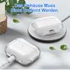 Two transparent earbud cases are shown, one connected to a charging cable and the other on a wireless charger, with green leaves scattered around. Produktbild-Vorschau