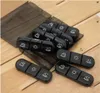 Several black pill organizers with day/time icons are laid out on a wooden surface. Podgląd zdjęcia produktu