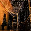 A balcony decorated with numerous strings of warm white fairy lights, with a Christmas tree visible on the left. Náhled obrázku produktu