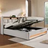 A bedroom scene featuring a bed with its storage compartment open, revealing stored items and illuminated by LED lighting. Náhled obrázku produktu