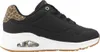 A side view of a black Skechers sneaker with leopard print detailing on the heel. Voir les images du produit