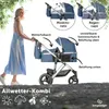 A woman pushing a blue and silver stroller in an outdoor setting. Produktbild-Vorschau