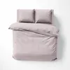 A top-down view of a neatly made bed with pink striped bedding and two pillows. Anteprima dell’immagine prodotto