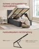 A woman is demonstrating the hydraulic lift system of a bed frame, showing how it opens to reveal storage space underneath. The image also includes a diagram of the hydraulic mechanism with specifications. Produktbild-Vorschau