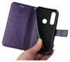 A hand holding a purple flip phone case with floral and butterfly embossing. Produktbild-Vorschau