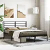 A bedroom scene featuring a black metal bed frame with bedding. Náhled obrázku produktu