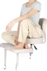 A person sitting on a chair with their legs crossed. Náhľad obrázku produktu