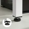 Close-up of the adjustable foot of a white table leg, shown on a light gray floor. A circular inset shows a diagram of how the foot adjusts. Produktbild-Vorschau