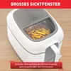 A white and gray air fryer with french fries inside, shown on a wooden surface. Produktbild-Vorschau