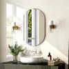A modern bathroom vanity with a sink, mirror, and wall sconces. Náhľad obrázku produktu